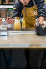 professional bartender making a delicious refreshing mojito cocktail