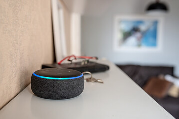 Rio de Janeiro, Brazil - January 28 2021: Amazon Echo Dot smart speaker with integrated Alexa voice assistant, home office.