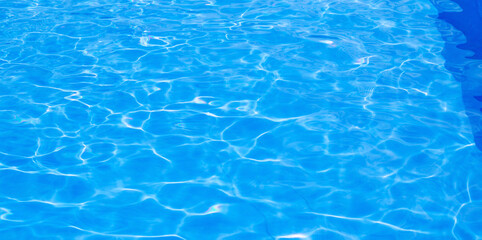 The water in the pool shimmers in the sun. Sun glare in the blue pool. Beautiful holiday banner....