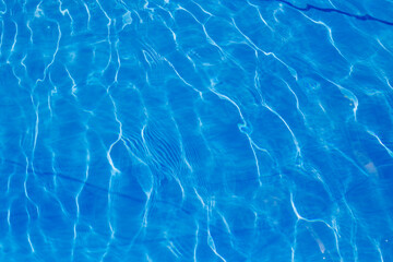 Beautiful blue water pattern. The sun is shining in the pool. Lovely tropical getaway and relax....