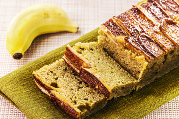 long banana cake made with organic banana, cinnamon and oatmeal, sliced. Brazilian homemade cake