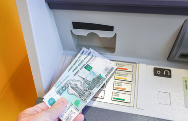 Depositing and withdrawing cash russian roubles banknotes from an ATM