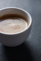 Cup of coffee on dark stone background. Close up. Copy space.	