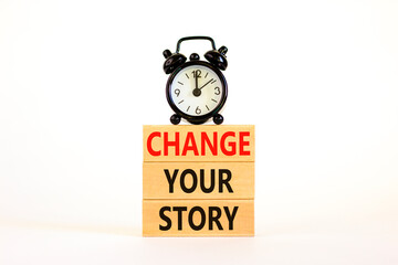 Change your story symbol. Concept words Change your story on wooden blocks on a beautiful white table white background. Black alarm clock. Business, finacial and change your story concept. Copy space.