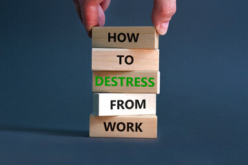 Destress from work symbol. Concept words How to destress from work on wooden blocks. Doctor hand. Beautiful grey background. Psychological business and destress from work concept. Copy space.