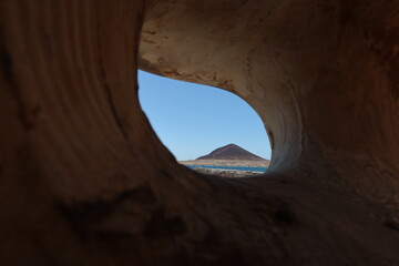El Medano, Tenerife, Spain, March 8, 2022: Red Mountain seen from inside a sculpture in El Medano, Tenerife, Spain