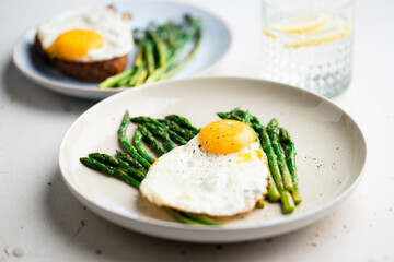 Fried eggs with green asparagus. Fast lunch ideas, healthy breakfast, summer food.