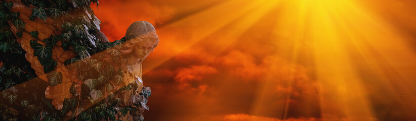 Angel in sun rays against dramatic view of cloudy sky. Copy space for text or design.