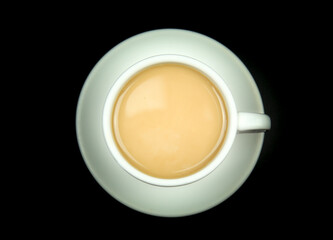 Cup of coffee and milk on black background