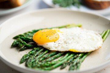 Fried eggs with green asparagus. Fast lunch ideas, healthy breakfast, summer food.