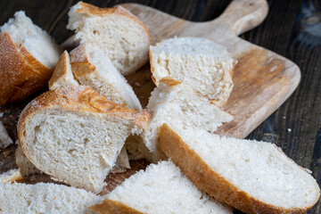 sliced loaf of bread on a cutting wooden board