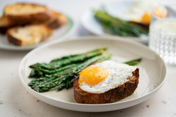 Fried eggs with toasted bread and green asparagus. Fast lunch ideas, healthy breakfast, summer food.