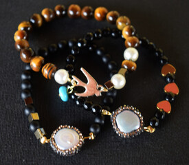 A set of bracelets on a black surface,isolated bracelets