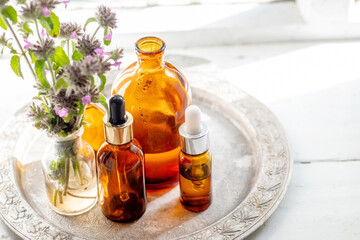 Still life with a bouquet of flowering Clinopodium vulgare, wild basil on an old vintage windowsill with wooden frames