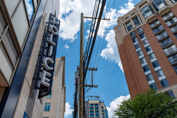 A vertical "police" sign outside of a police station in suburban Washington, DC.