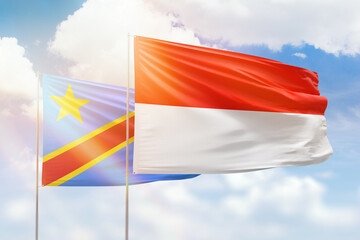 Sunny blue sky and flags of indonesia and dr congo