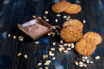 oatmeal cookies with peanuts on a black wooden table