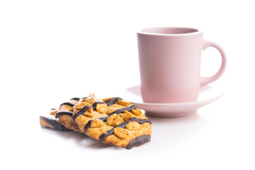 Chip cookies with peanuts and chocolate strips and coffee cup isolated on white background.