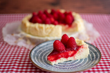 Delicious slice of cheesecake decorating with raspberries