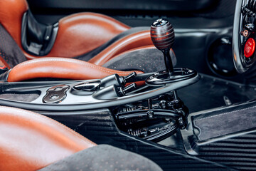 Side view of a hyper car automatic shifter and interior