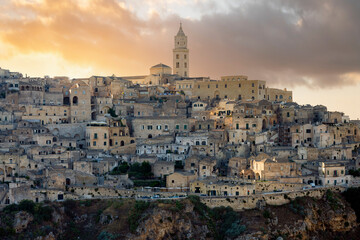 Naklejka premium Stunning view of the Matera’s skyline during a beautiful sunset. Matera is a city on a rocky outcrop in the region of Basilicata, in southern Italy