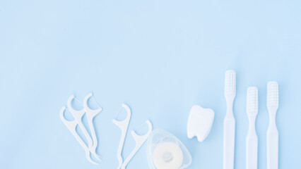 White oral care tools on blue background