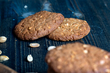 oatmeal cookies with peanuts on a black wooden table