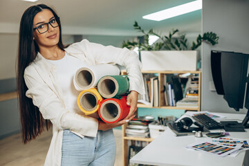 Woman designer with colorful paper at an office