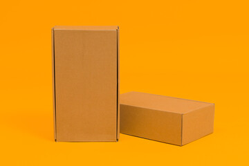 two cardboard boxes on a yellow background, the concept of delivery or moving