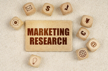 On the fabric there are cubes with drawings and a sign with the inscription - MARKETING RESEARCH