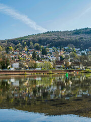 Fototapeta na wymiar Vertical shot of Heidelberg village houses reflection on Neckar river, Germany