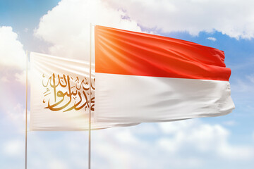 Sunny blue sky and flags of indonesia and afghanistan