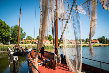 Enkhuizen, Netherlands, June 2022. Traditional fishing boats and nets hanging out to dry at the...