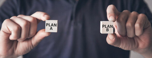 Male hands showing Plan A and Plan B. Business concept