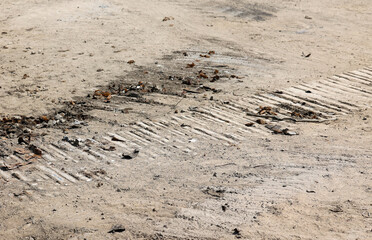 Dirty old earth with traces of machine heavy equipment with rusty metal and stones