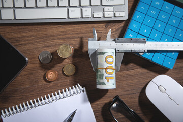 Caliper with a coins, money and calculator.