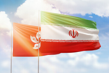Sunny blue sky and flags of iran and hong kong