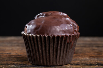 chocolate cupcake in black paper packaging