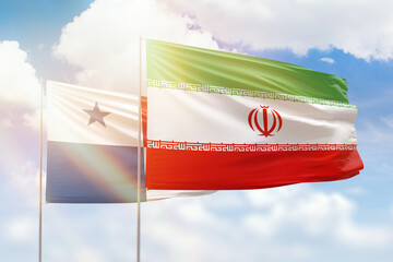 Sunny blue sky and flags of iran and panama