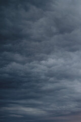 Dark rain clouds in the evening sky. Dramatic sky with an coming cloudy cyclone of bad weather