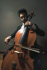 Classic cello player performing with suit © federico