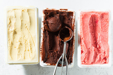 real Italian artisanal ice cream in packing box: chocolate, strawberries, vanilla with berries and...