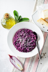 Italian risotto with blueberries and red onions with cheese and sage on the table