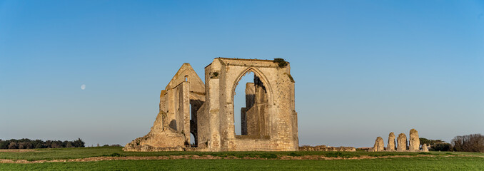 panorama of chateliers abbey with moon in the sky
