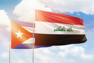 Sunny blue sky and flags of iraq and cuba