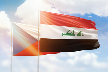 Sunny blue sky and flags of iraq and czechia