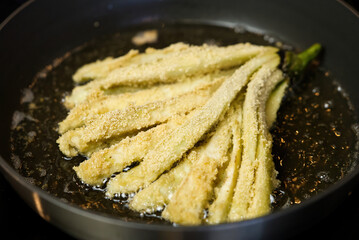 Eggplant fried in a pan in boiling oil. close up