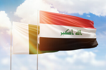 Sunny blue sky and flags of iraq and pakistan