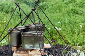 Hiking pot, Bowler in the bonfire. in cauldron at the stake. Traveling, tourism, picnic cooking,...