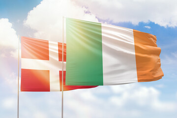 Sunny blue sky and flags of ireland and denmark